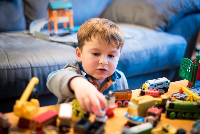 A young boy playing with toys